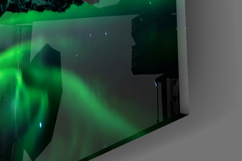 Close-up detail of the aurora ribbons repeated in still black water on the glass surface