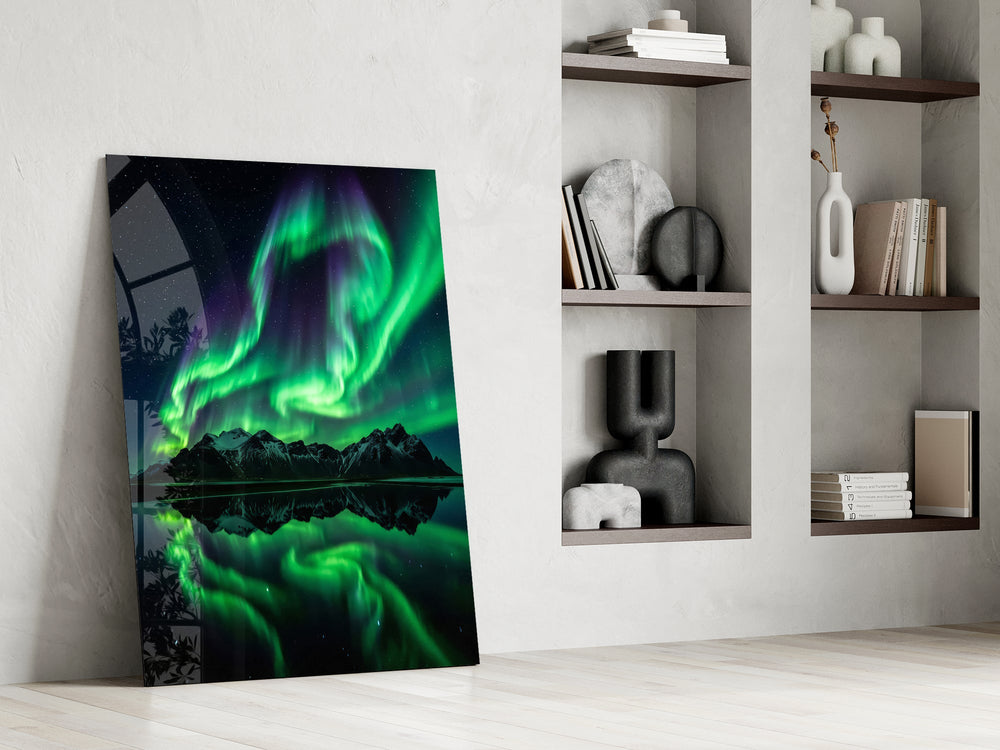 a green aurora over mirrored peaks panel resting in a shelving niche in a modern interior
