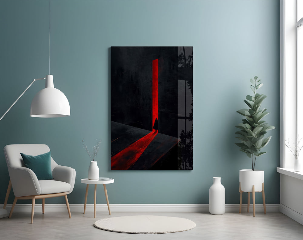 a cloaked figure at a red doorway glass wall art styled above an armchair in a reading corner