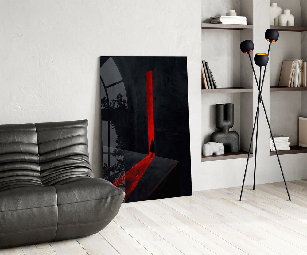 a cloaked figure at a red doorway glass wall art leaning beside a dark leather sofa