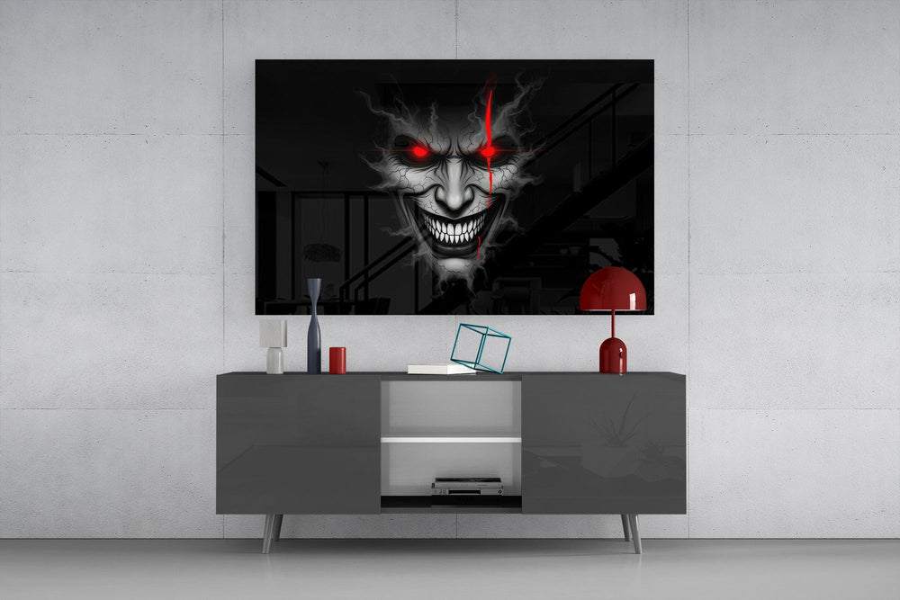 cracked gray grinning demon face glass wall art displayed above a console in a designer interior