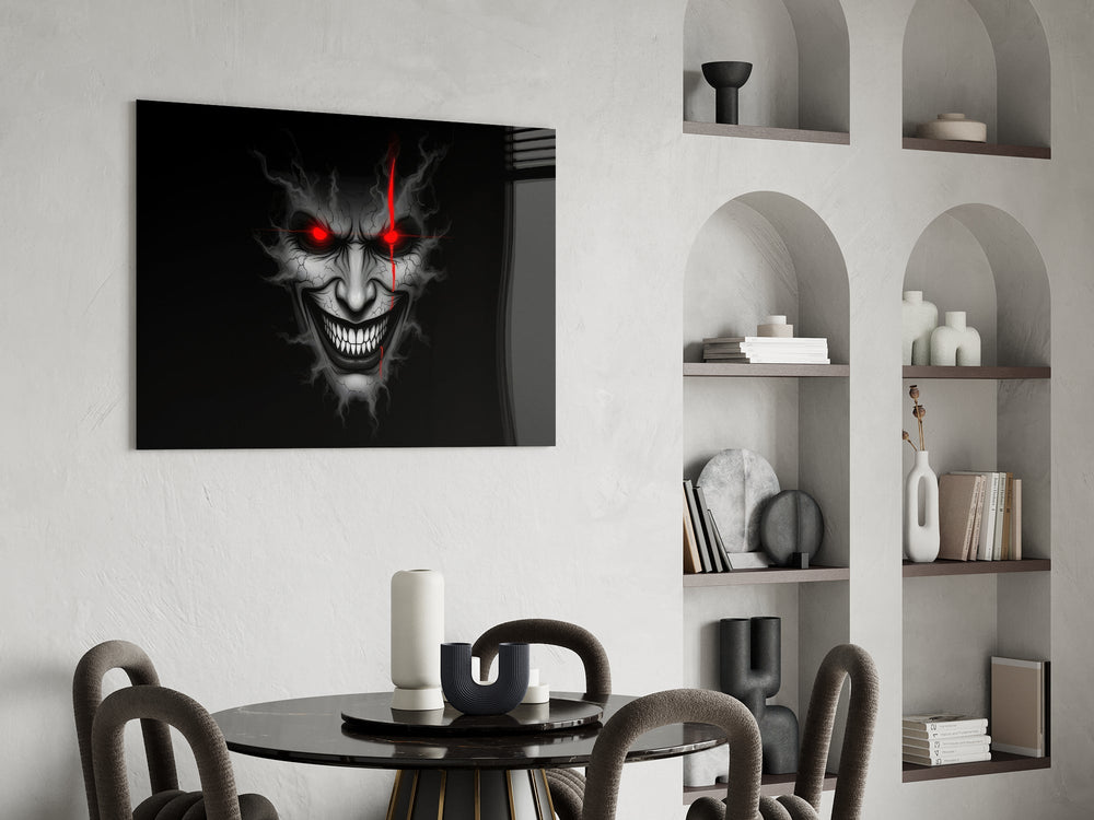 cracked gray grinning demon face glass wall art leaning beside a dark leather sofa