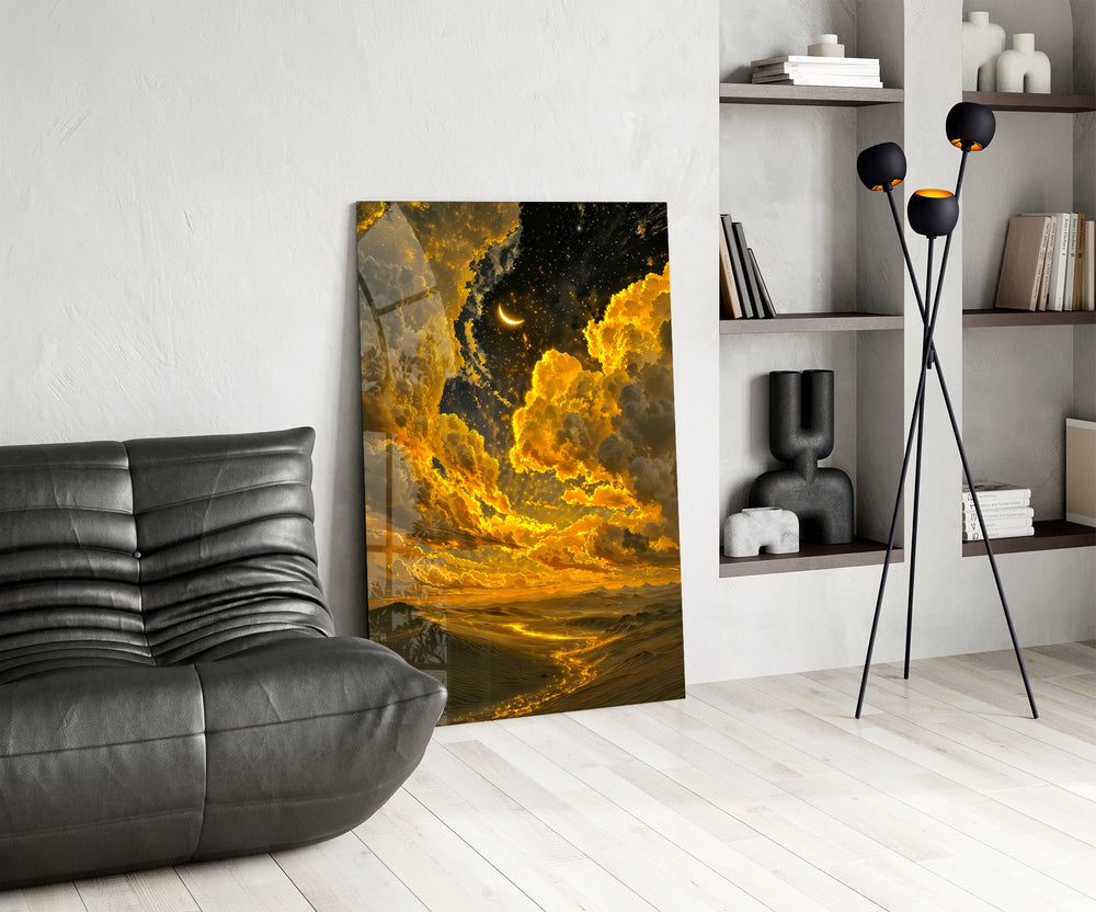golden clouds and a crescent moon over desert dunes glass wall art leaning beside a dark leather sofa