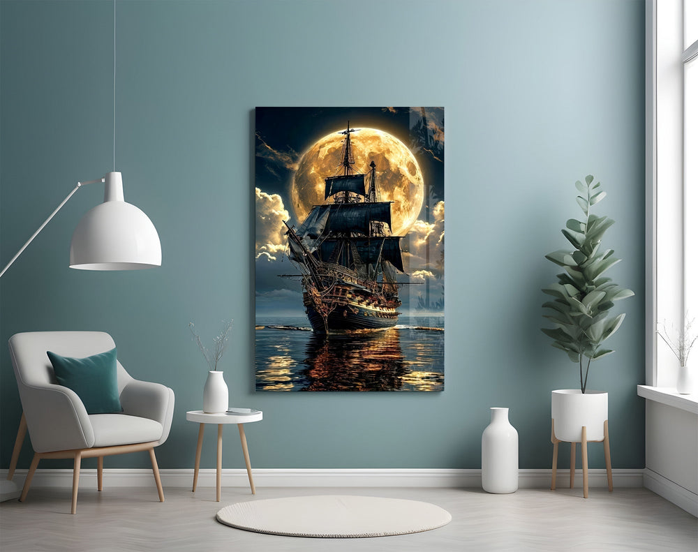 tall sailing ship before a full moon glass wall art styled above an armchair in a reading corner