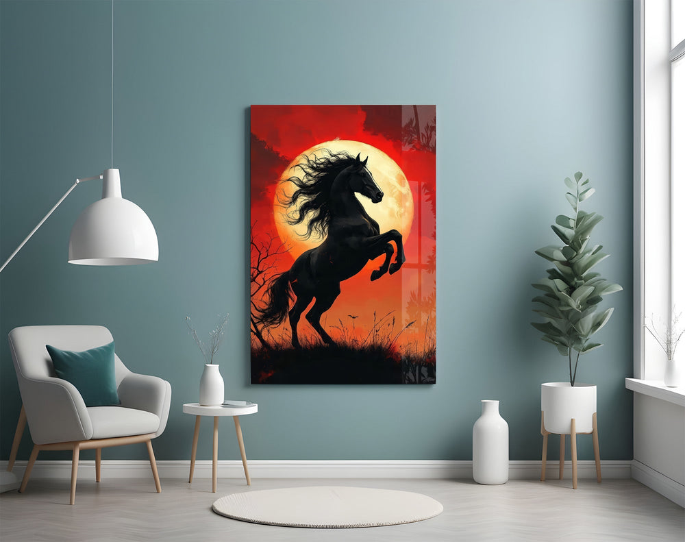 a rearing black horse under a red moon glass wall art styled above an armchair in a reading corner