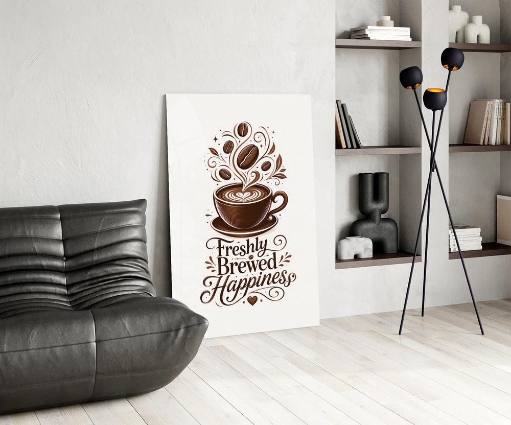 a latte-art coffee cup with hand lettering glass wall art leaning beside a dark leather sofa