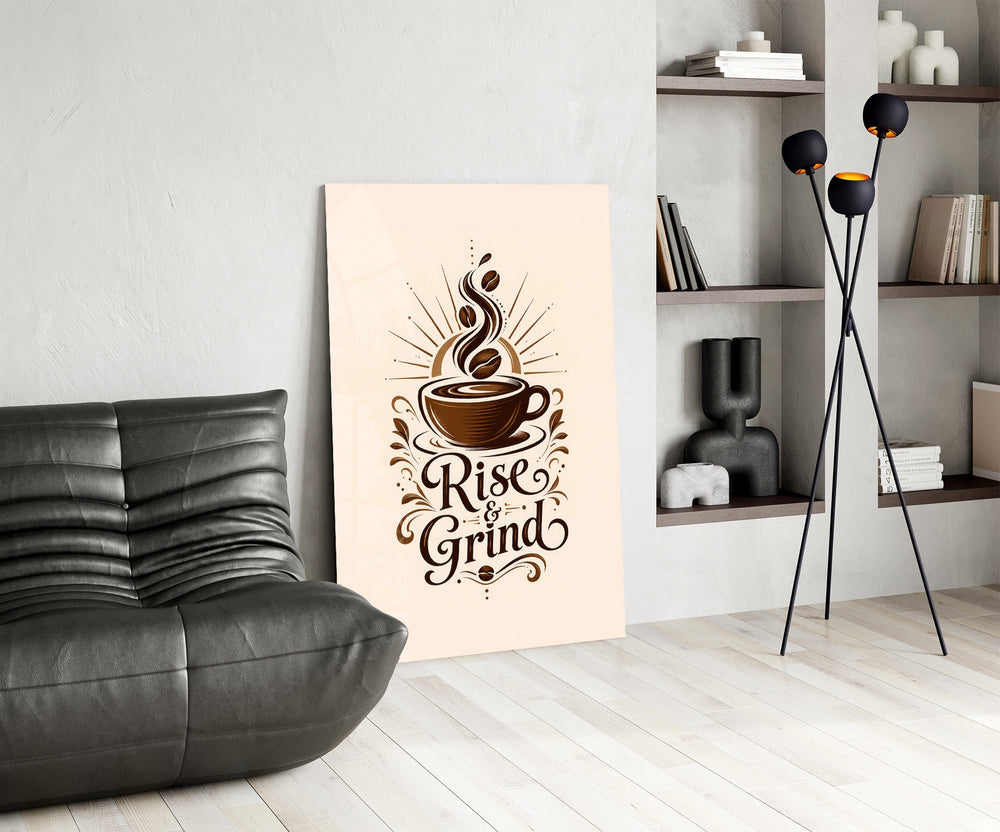 a coffee cup with a sunburst and lettering glass wall art leaning beside a dark leather sofa