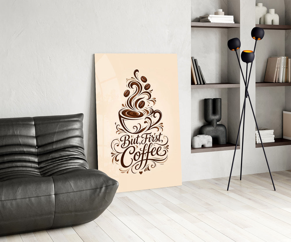 brown script coffee cup typography glass wall art leaning beside a dark leather sofa