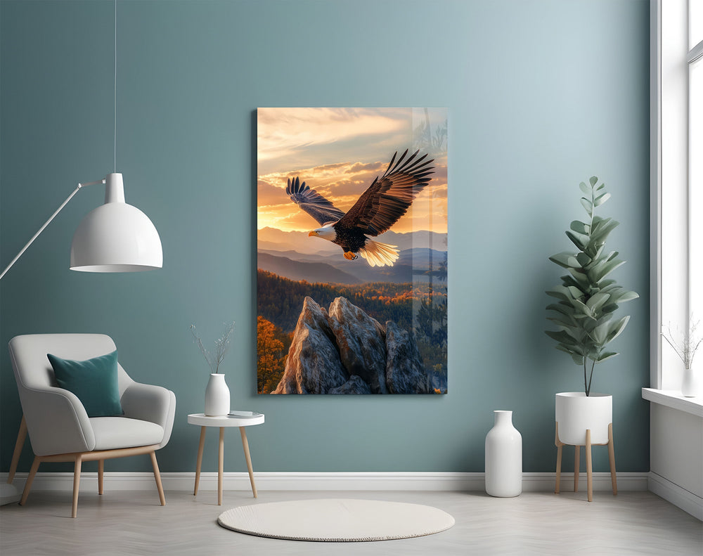 a bald eagle over autumn mountains at sunset glass wall art styled above an armchair in a reading corner