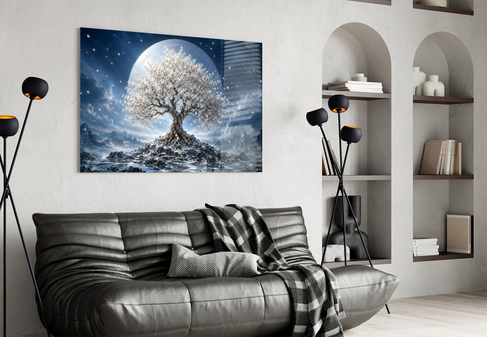 a white blossom tree beneath a full moon glass wall art styled above an armchair in a reading corner