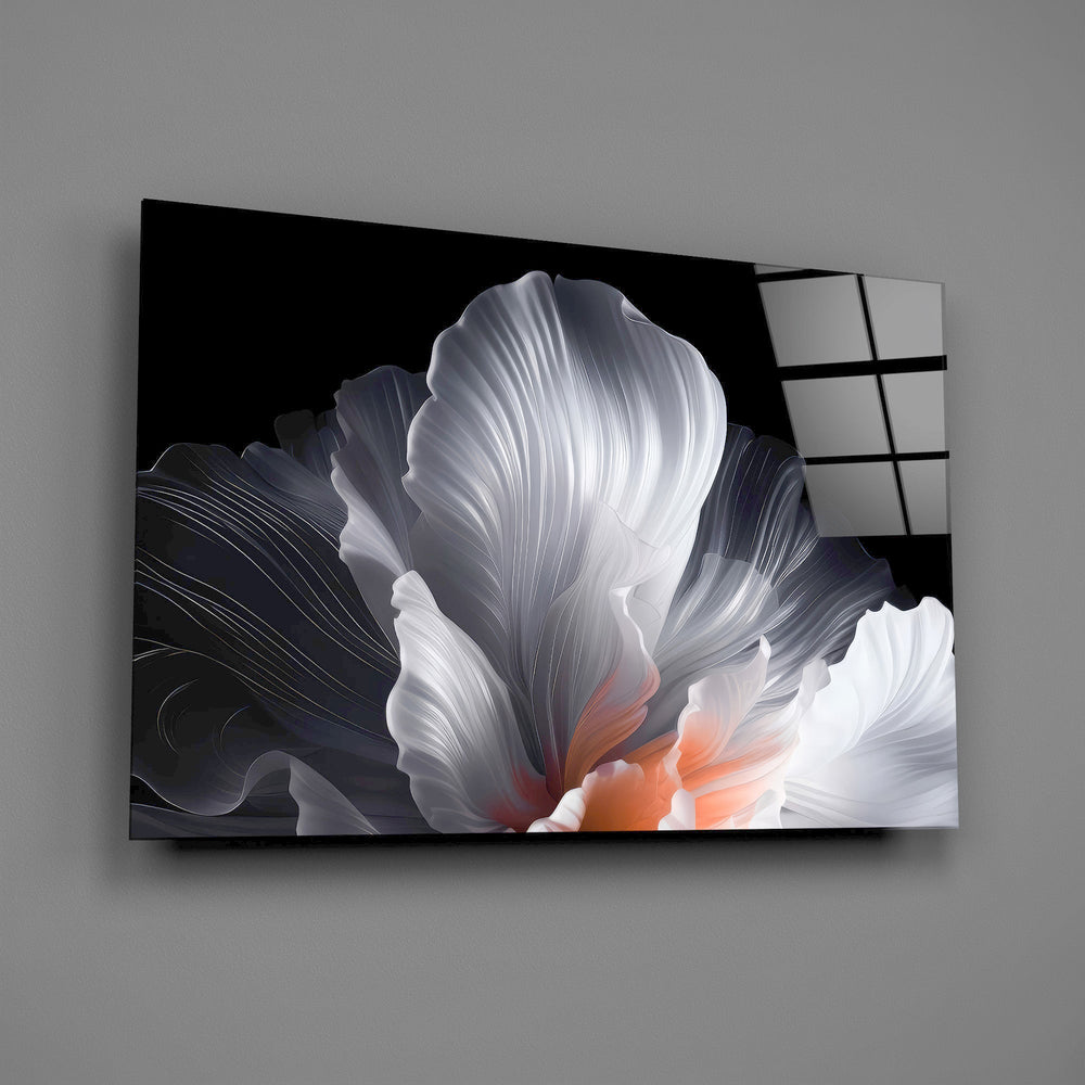 an abstract white flower on black glass wall art angled to show the polished tempered glass panel