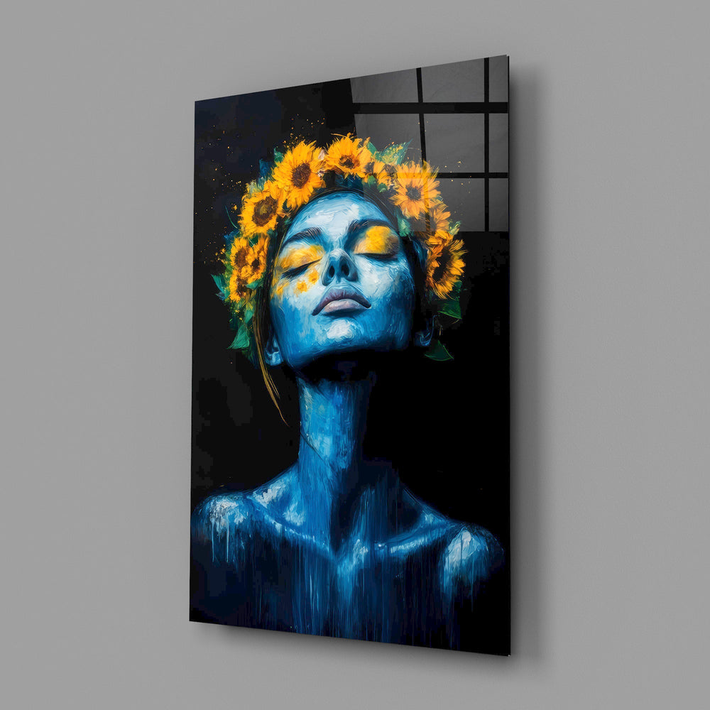 a blue-skinned woman crowned with sunflowers glass wall art angled to show the polished tempered glass panel