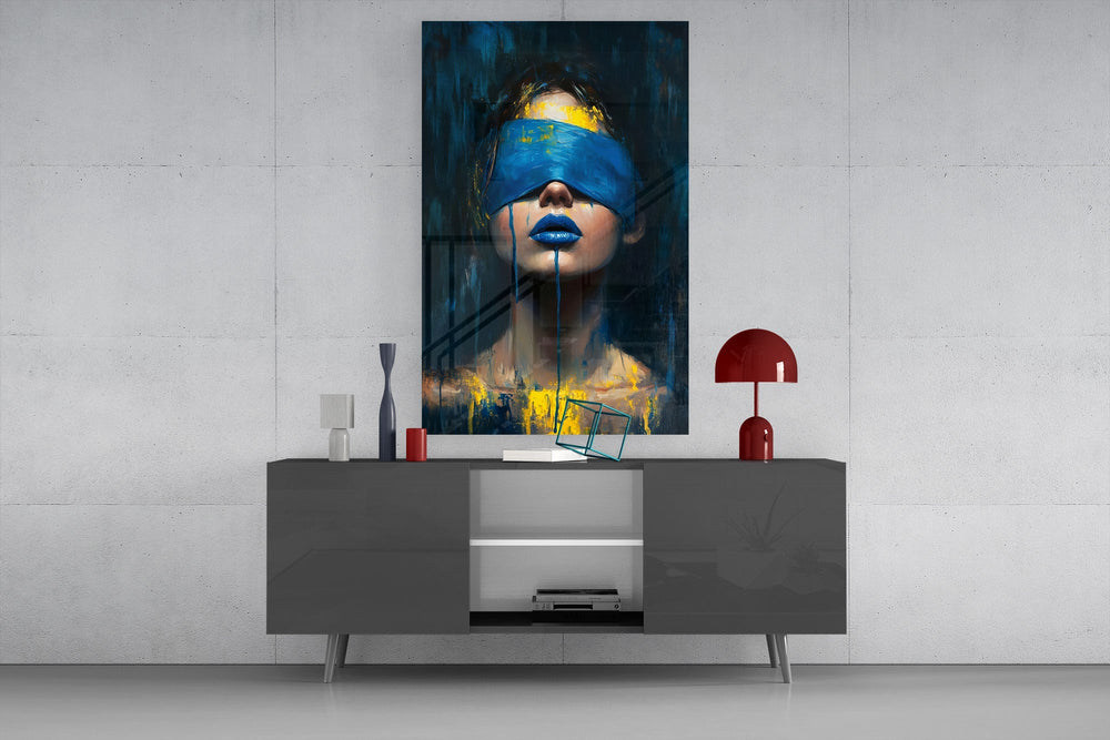 a blindfolded woman with blue lips and dripping paint glass wall art styled in an atmospheric room setting