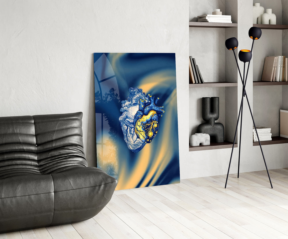 golden starry anatomical heart glass wall art leaning beside a dark leather sofa