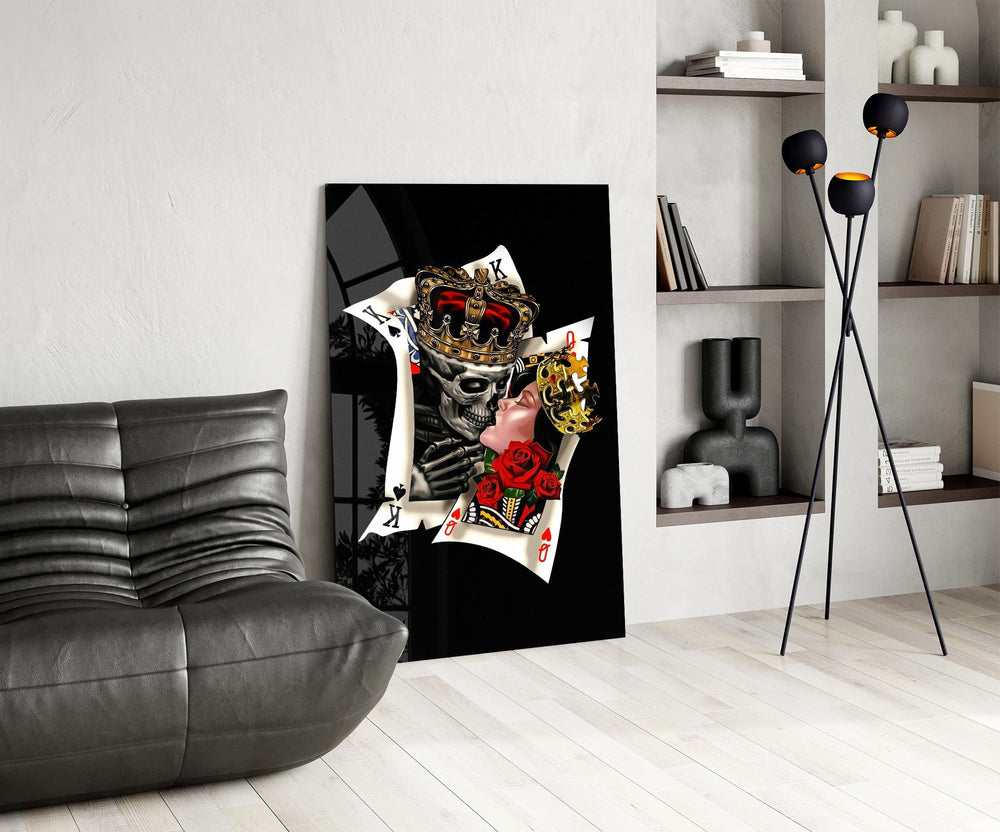skull king and masked queen cards glass wall art leaning beside a dark leather sofa