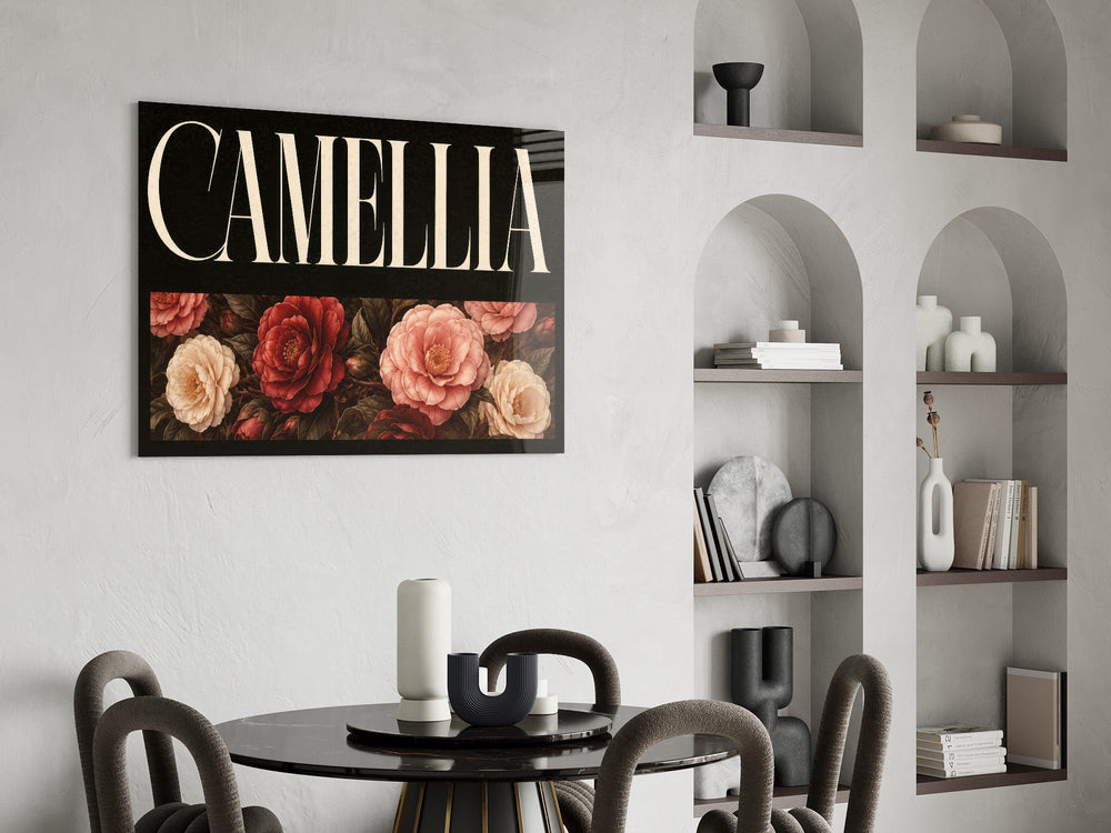 camellia bloom typography glass wall art leaning beside a dark leather sofa