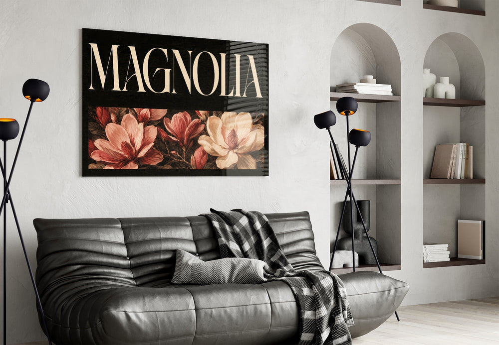 magnolia bloom typography glass wall art styled above an armchair in a reading corner