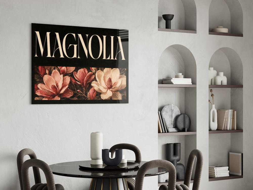 magnolia bloom typography glass wall art leaning beside a dark leather sofa