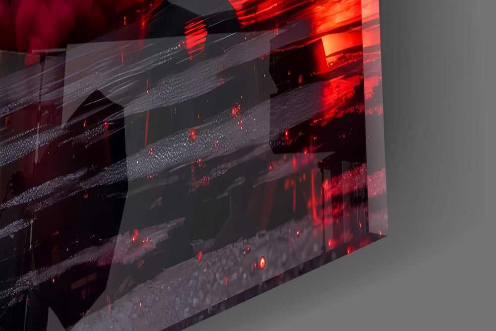 Close-up detail of the glossy black bodywork and red-lit alloy wheels on the glass surface