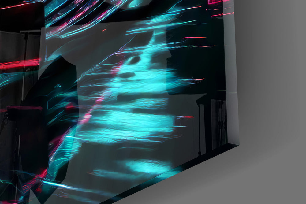 Close-up detail of the amber-rimmed tyres and cyan neon light trails on the glass surface
