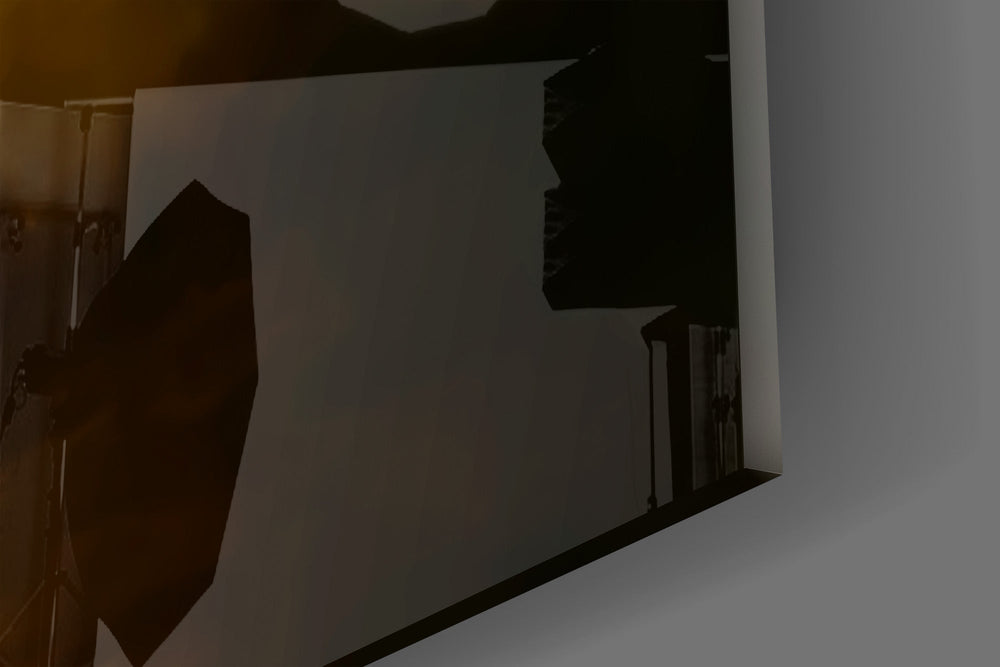 Close-up detail of the cream ribboned sleeve and the outstretched fingers on the glass surface