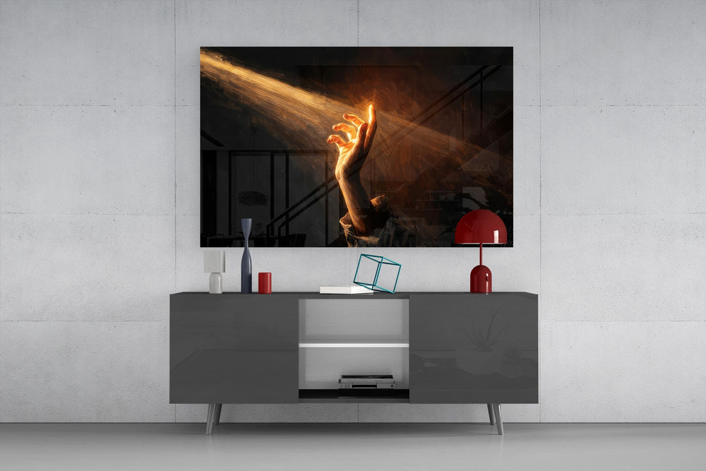 a hand reaching into a golden light beam glass wall art styled in an atmospheric room setting