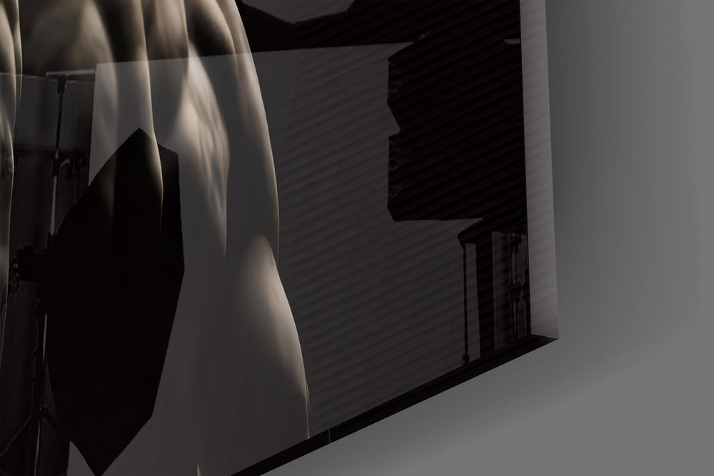 Close-up detail of the carved marble curls and shadowed shoulders on the glass surface