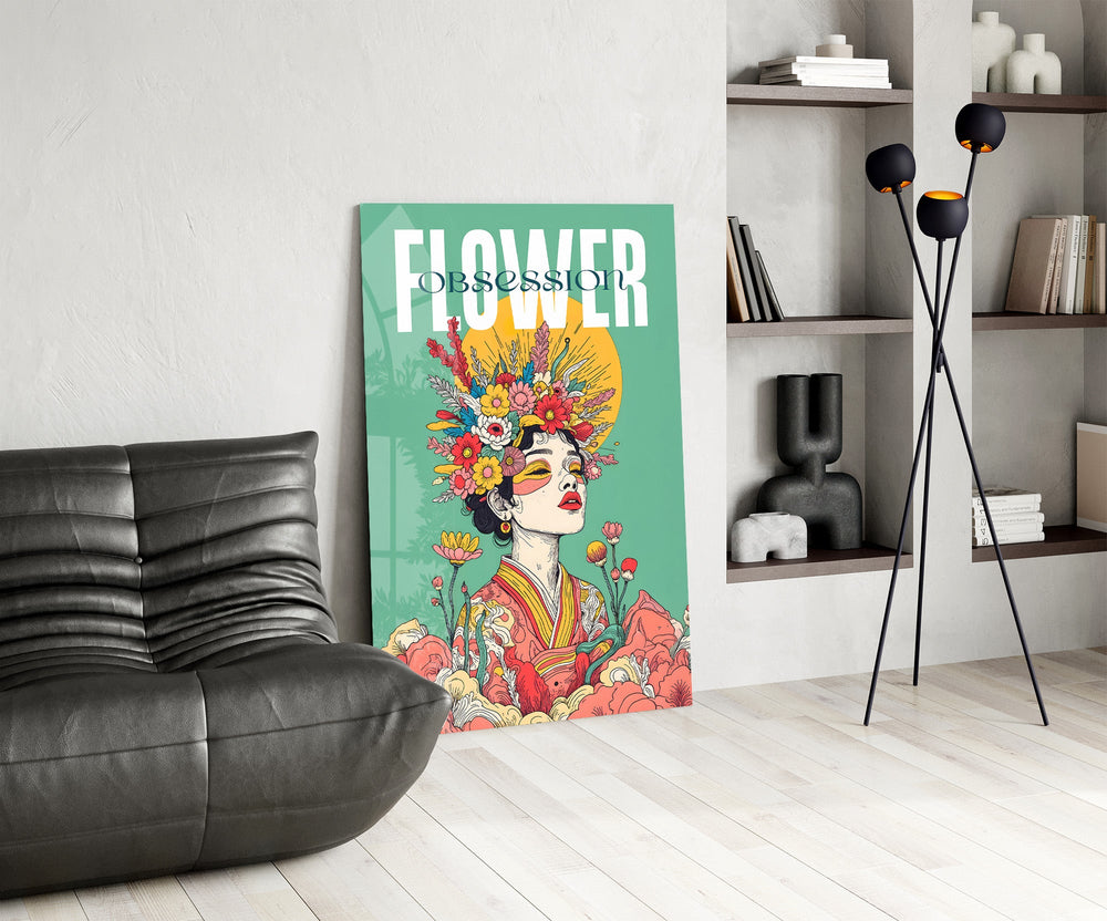 a woman crowned with wildflowers glass wall art leaning beside a dark leather sofa