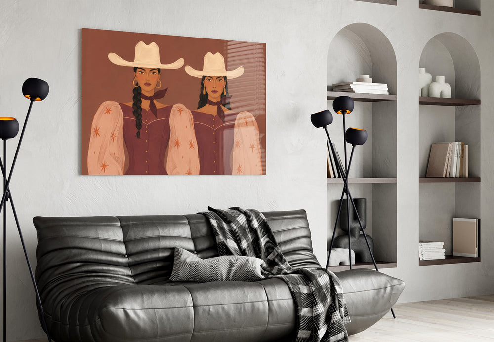 two cowgirls in matching western dresses glass wall art styled above an armchair in a reading corner