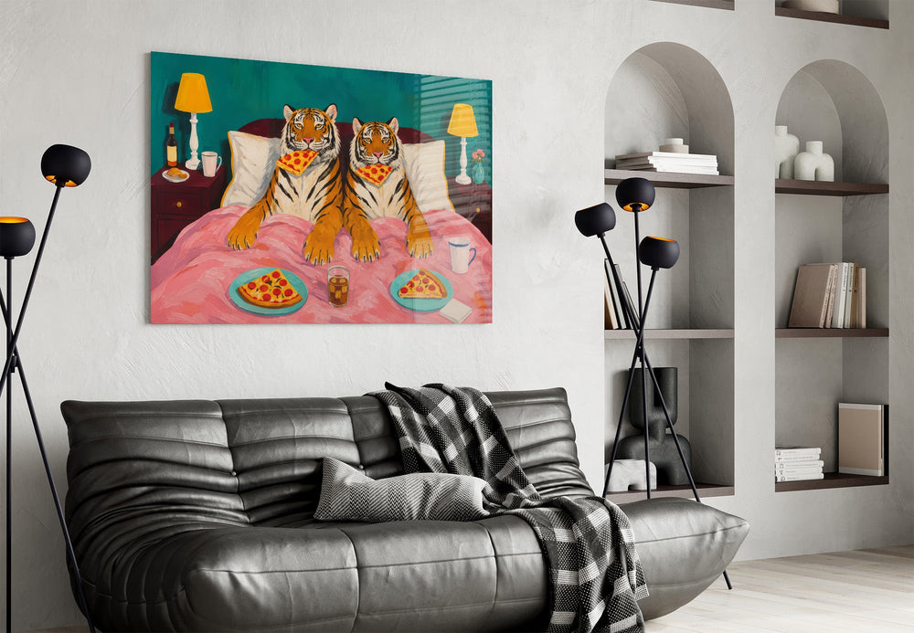 two tigers lounging in bed with pizza glass wall art styled above an armchair in a reading corner