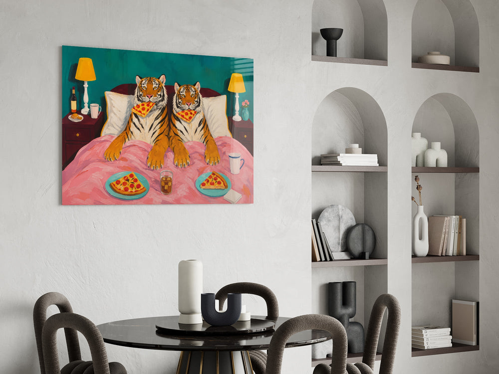 two tigers lounging in bed with pizza glass wall art leaning beside a dark leather sofa