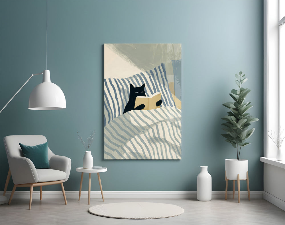 black cat reading in striped bedding glass wall art styled above an armchair in a reading corner