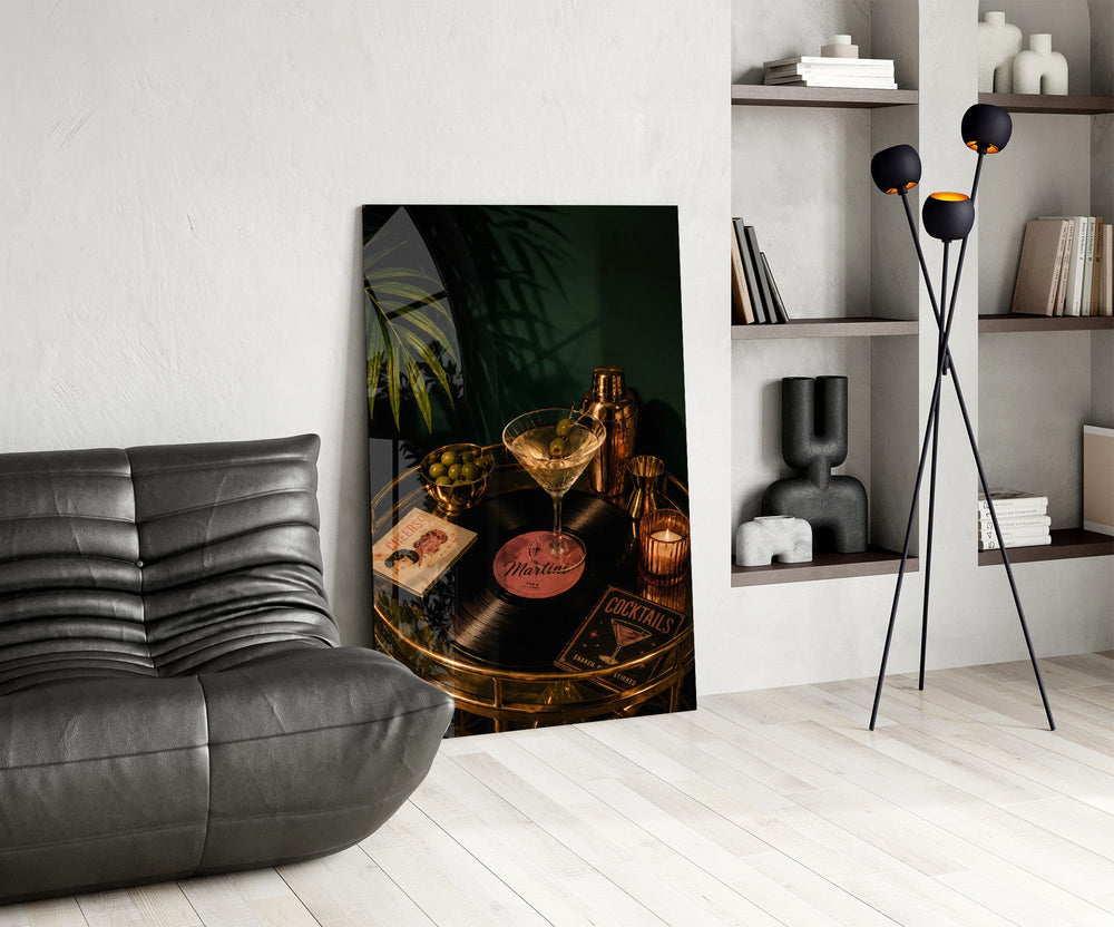 martini cocktail on a golden bar cart glass wall art leaning beside a dark leather sofa