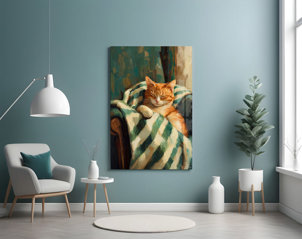 sleeping ginger cat in a striped blanket glass wall art styled above an armchair in a reading corner