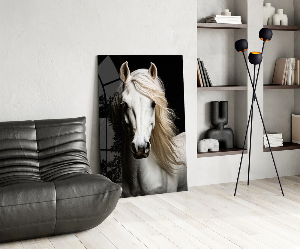 white horse portrait on black glass wall art leaning beside a dark leather sofa