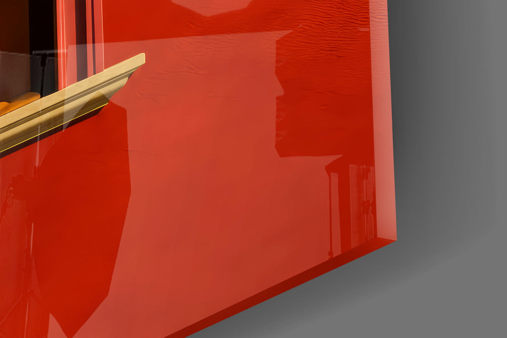 Close-up detail of the open orange book hiding the face and the bare legs on the sill on the glass surface