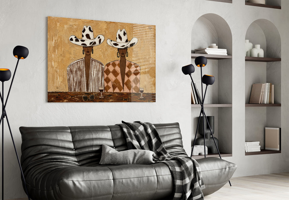 two women in cow-print cowboy hats glass wall art styled above an armchair in a reading corner