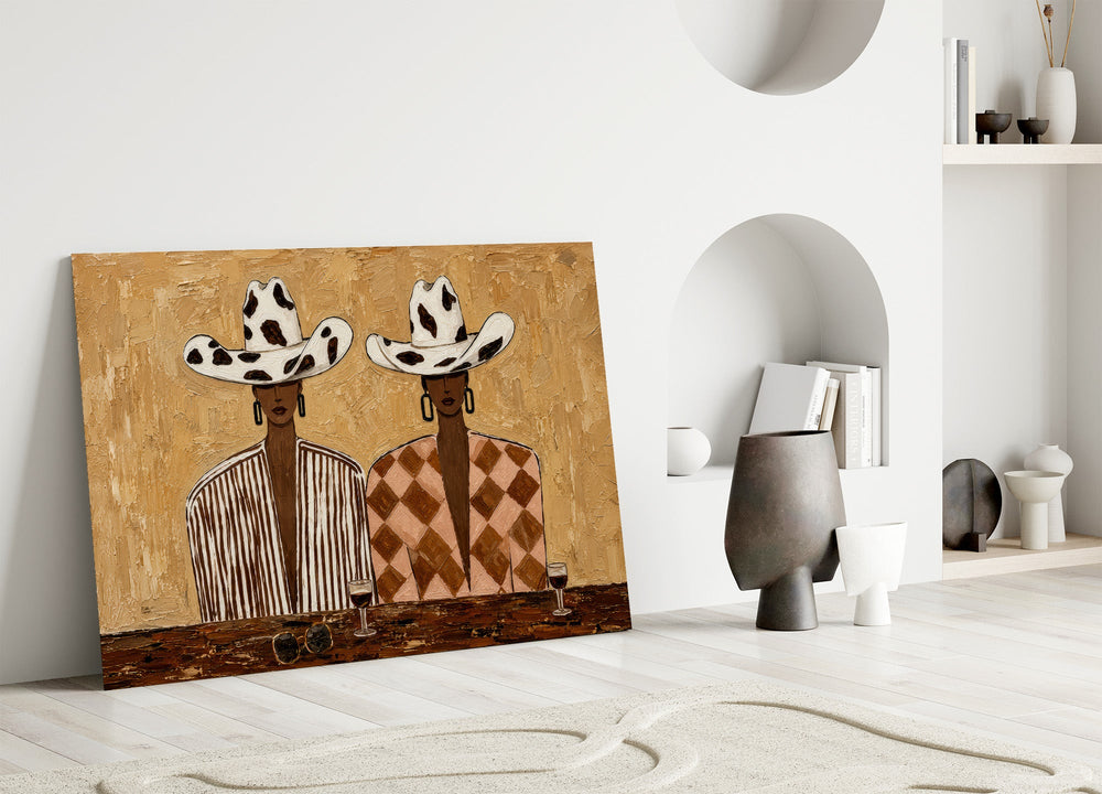 two women in cow-print cowboy hats panel bringing character to a minimalist living room wall