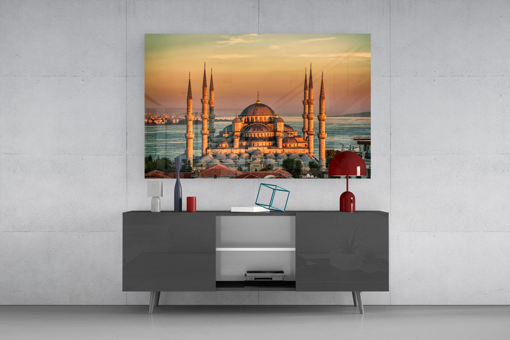 golden sunset six-minaret mosque glass wall art styled in an atmospheric room setting