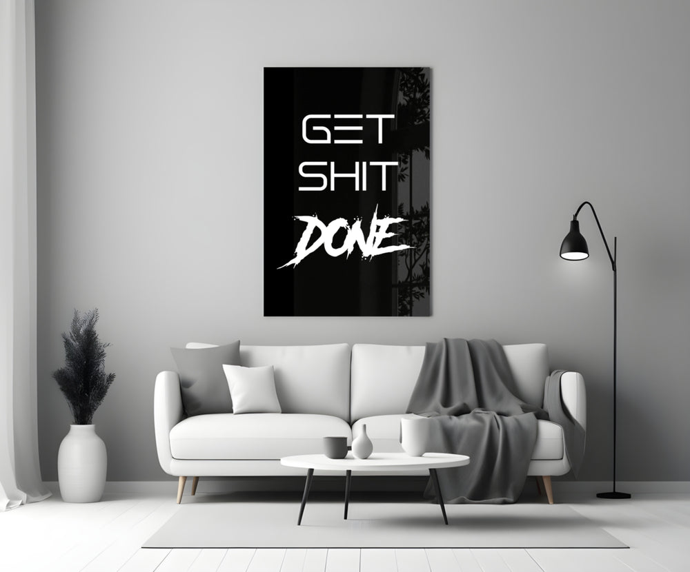 Typographic artwork anchoring a desk wall with white-on-onyx palette
