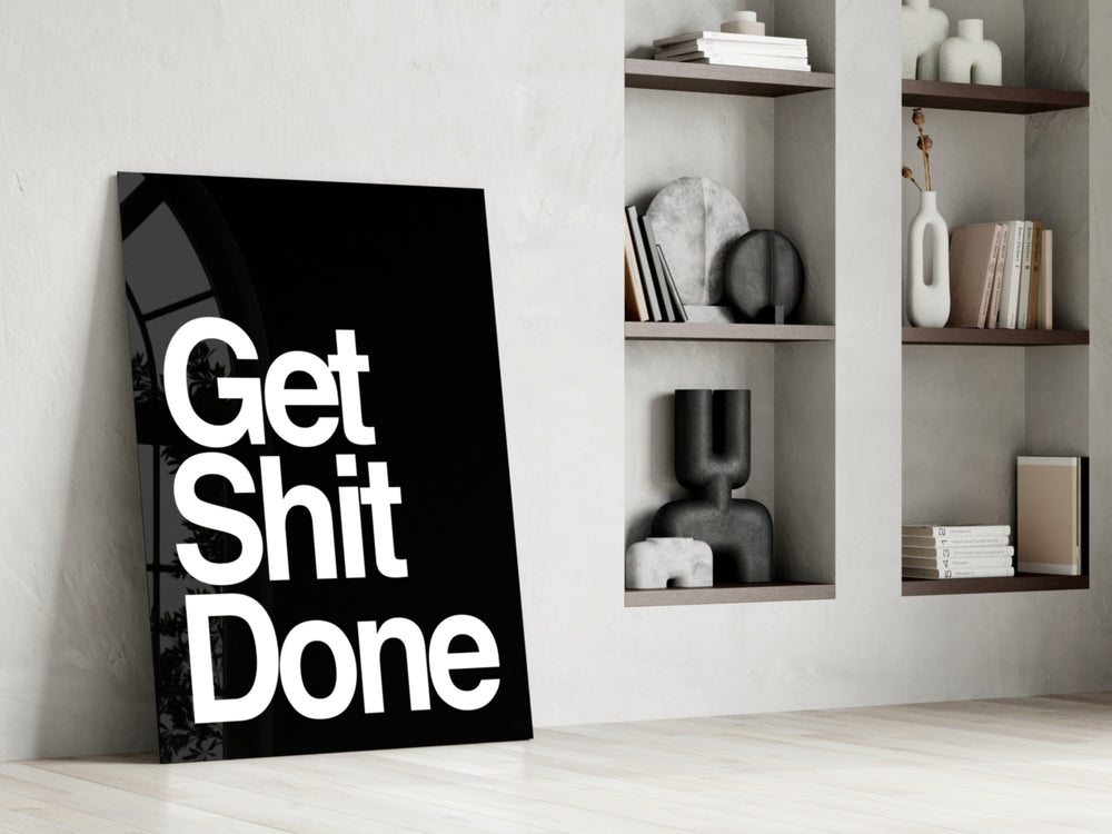 Typographic artwork anchoring a desk wall with white-on-onyx palette
