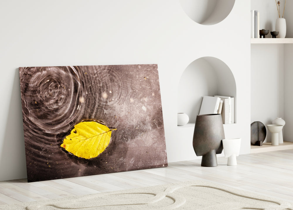 Yellow Leaf glass wall art hanging above a modern sofa in a warm neutral living room