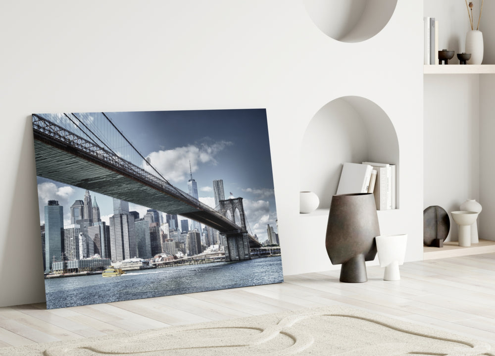 Manhattan Bridge glass wall art styled above a sofa in a modern loft
