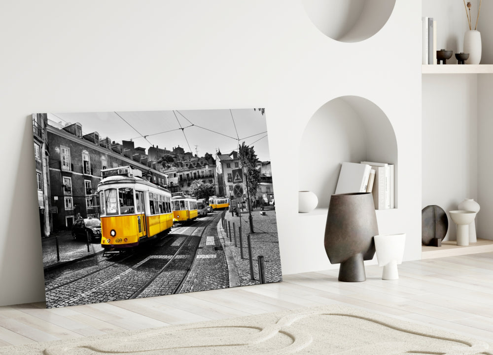 Yellow Tram glass wall art styled above a sofa in a travel-inspired living room