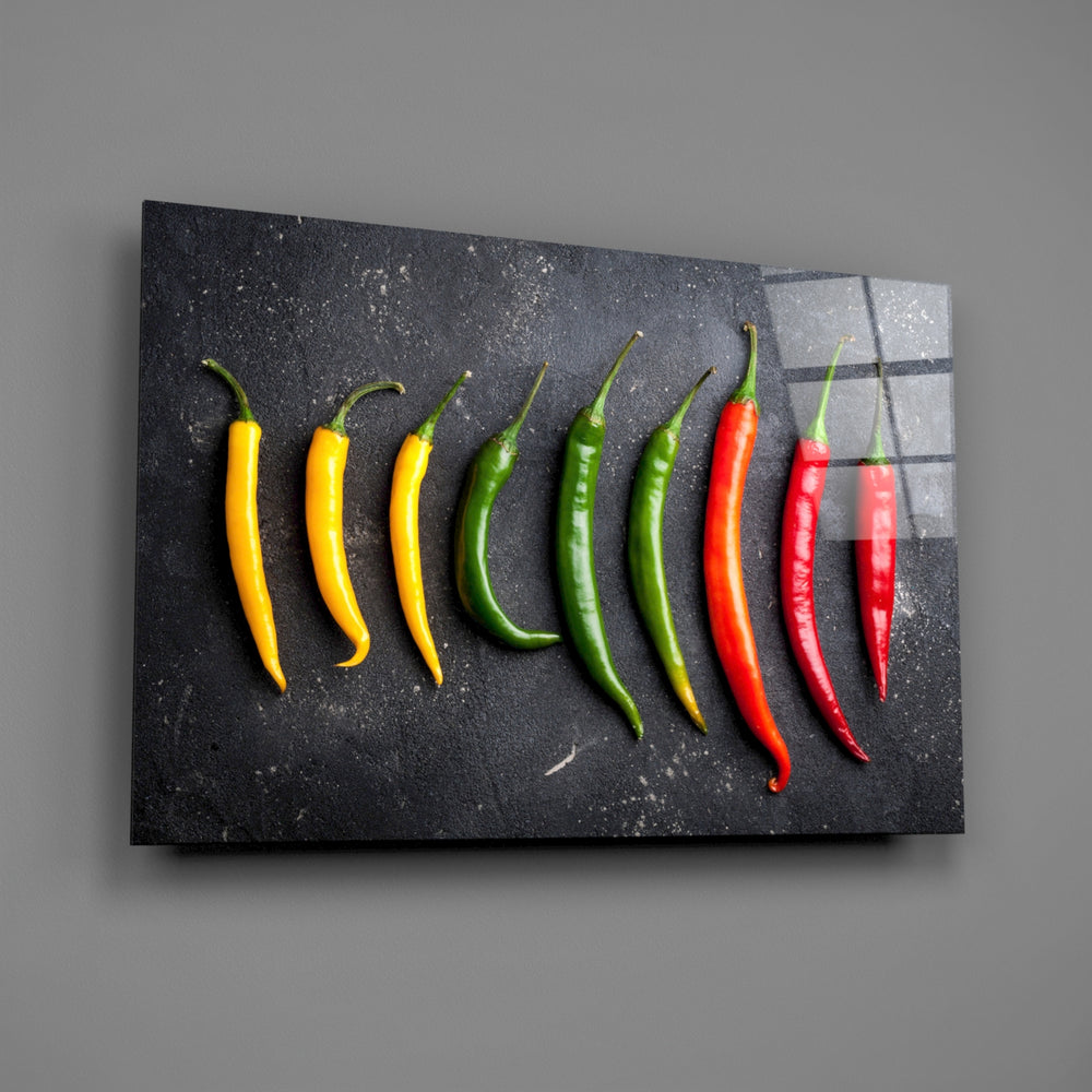Close-up detail of glossy yellow, green, and red peppers on dark ground
