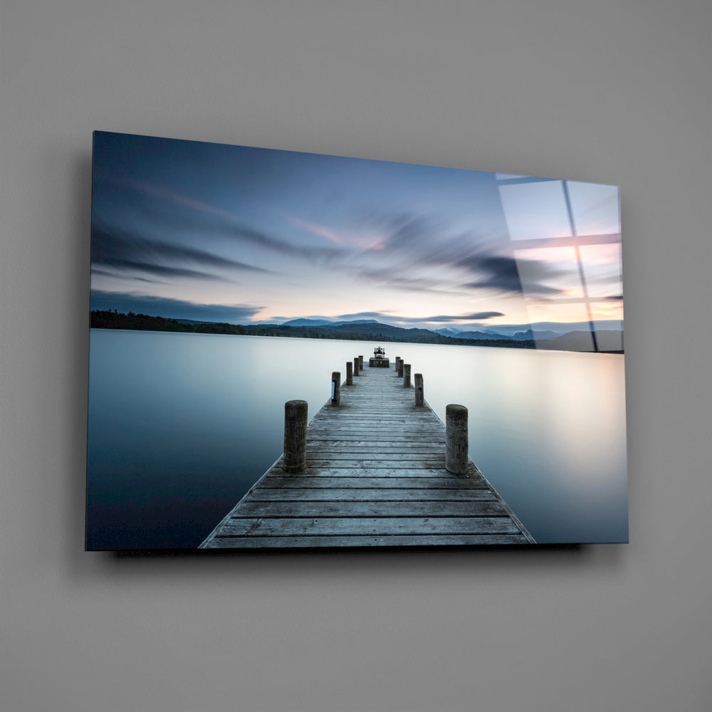 Close-up detail of the weathered wooden dock leading into still water
