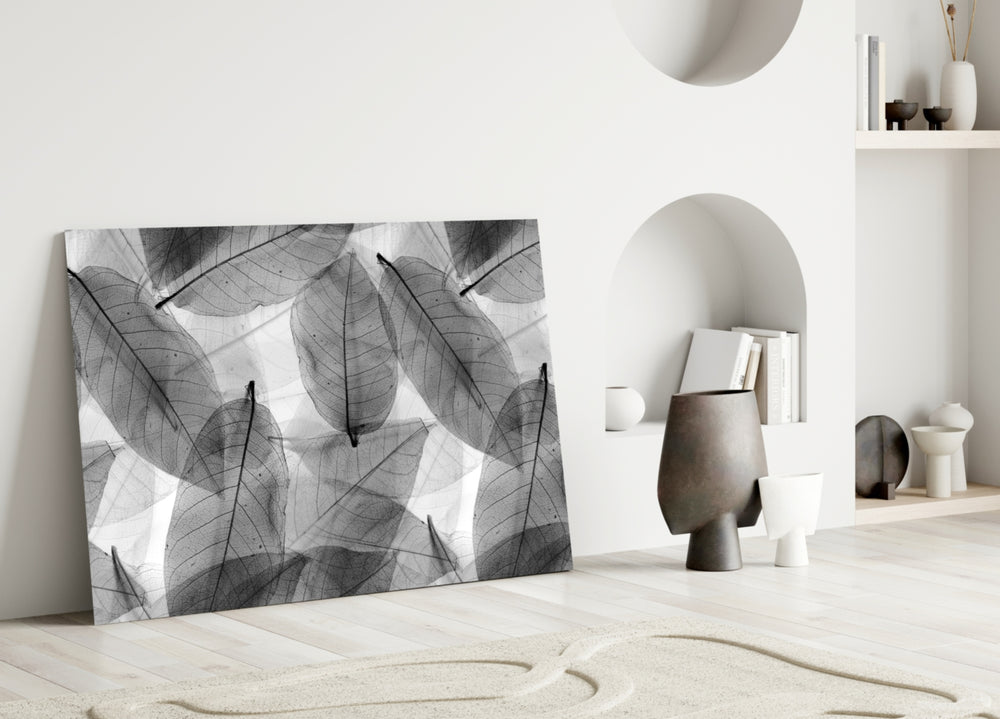 Black and White Leaves glass wall art styled above a bed in a modern bedroom