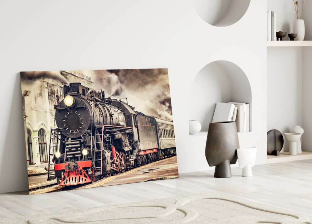 Train glass wall art styled above a leather sofa in a study or library