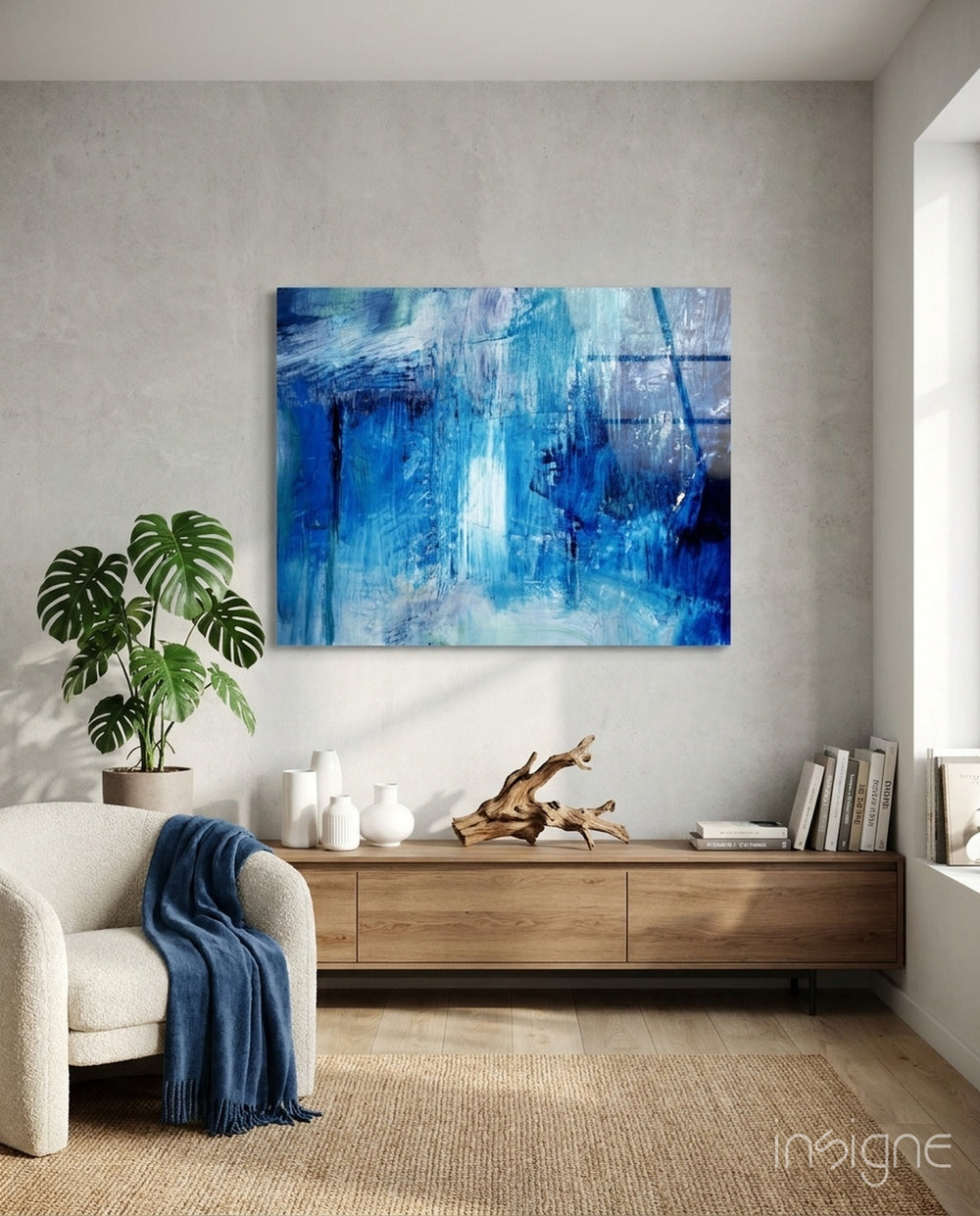 Abstract blue glass wall art displayed above a console in a designer interior