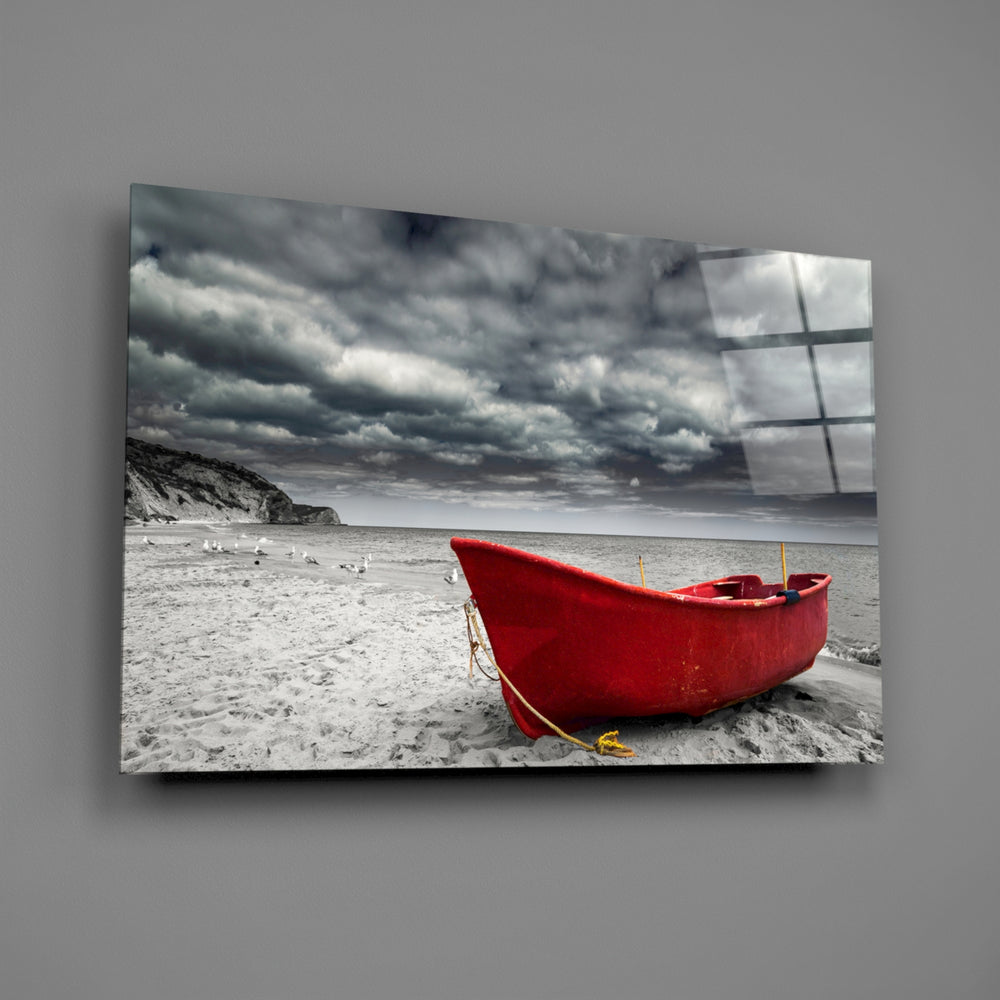 Close-up detail of the scarlet wooden boat against gray sand and sky